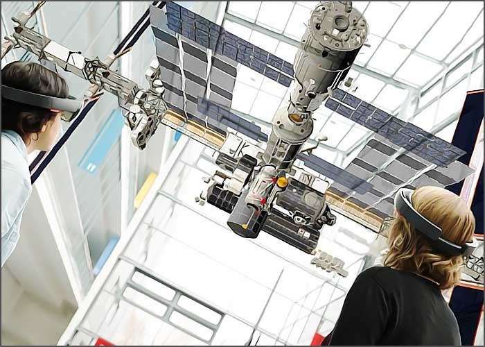 Robot industriel suspendu manipulé par des techniciens.